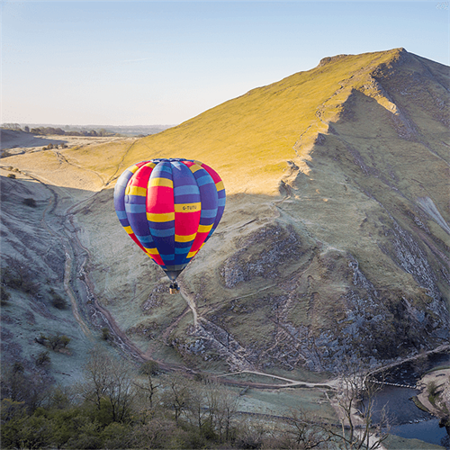 Multicoloured Balloon flying over mountains Multicoloured Balloon flying over mountains